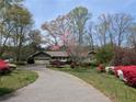 Charming single-story home with a well-manicured front yard and a long, winding driveway at 4258 Rocky Ledge Way, Snellville, GA 30039