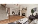Inviting living room features a stone fireplace, hardwood floors and a staircase to the upper level at 507 Grove Field Ct, Suwanee, GA 30024