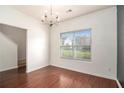 Bright dining room with hardwood floors, chandelier, and large window providing ample natural light at 2236 Bigwood Trl, Atlanta, GA 30349