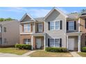Charming home featuring neutral siding, brick accents, well-kept lawn, and inviting entrance at 2236 Bigwood Trl, Atlanta, GA 30349