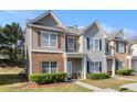 Charming home featuring neutral siding, brick accents, well-kept lawn, and inviting entrance at 2236 Bigwood Trl, Atlanta, GA 30349