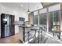 Modern kitchen with stainless steel appliances, mosaic backsplash, and island seating at 855 Peachtree Ne St # 1703, Atlanta, GA 30308