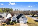 Charming one-story home featuring light gray siding, black shutters, a well-kept lawn, and a convenient attached garage at 165 Birch St, Hiram, GA 30141
