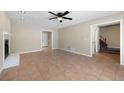 Spacious living room featuring a fireplace, tile floors, ceiling fan, and an open layout with staircase access at 2898 Lakemont Sw Dr, Marietta, GA 30060