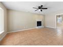 Bright living room featuring a fireplace, tile floors, ceiling fan, and an open layout to adjacent spaces at 2898 Lakemont Sw Dr, Marietta, GA 30060