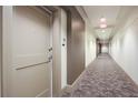 Interior hallway featuring neutral carpet and paint throughout the building at 905 Juniper Ne St # 110, Atlanta, GA 30309
