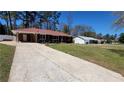 Lovely home with an expansive driveway leading to a convenient carport at 4715 Greensprings Rd, College Park, GA 30337