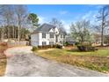 Expansive home featuring a long driveway, well-manicured lawn, and lush landscaping at 113 Willow Hill Ln, Stockbridge, GA 30281