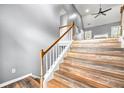 View of the wooden staircase with gray walls, wood-look floors and white trim at 113 Willow Hill Ln, Stockbridge, GA 30281