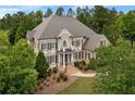 Stunning aerial view of home with a large roof, lush landscaping, and mature trees at 19 Troup Ct, Acworth, GA 30101