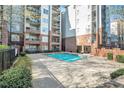 Inviting community pool surrounded by brick walls and lush landscaping for a relaxing atmosphere at 50 Biscayne Nw Dr # 5112, Atlanta, GA 30309