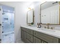 Bright bathroom features a double sink vanity with elegant gold fixtures and a glass-enclosed shower at 2411 Charleston Oaks Ln, Decatur, GA 30030