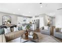 Open-concept living room and kitchen area with modern furniture and stainless steel appliances at 2098 Amaryllis Dr, Grayson, GA 30017