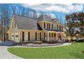 Lovely two-story home with a manicured lawn, a welcoming front porch, and a classic architectural style at 215 Morning Glory Rdg, Canton, GA 30115