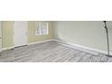 Bright living room featuring stylish gray wood-look floors and fresh paint at 3087 Colonial Way # J, Atlanta, GA 30341