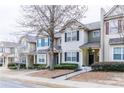 Street view of attractive townhomes featuring well-maintained landscaping and inviting covered entrances at 2449 Suwanee Pointe Dr, Lawrenceville, GA 30043