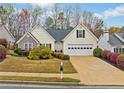 Inviting one-story home with a well-maintained lawn and blooming bushes at 455 Ellesmere Way, Buford, GA 30518