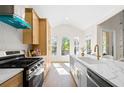 Modern kitchen with stainless steel appliances, a large center island, and a view of the backyard at 1288 Gate Post Ln, Powder Springs, GA 30127
