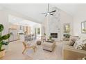 Bright and airy living room with a marble fireplace, cathedral ceiling, and an open-concept kitchen at 1288 Gate Post Ln, Powder Springs, GA 30127