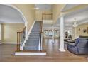 Grand foyer featuring hardwood floors, staircase with decorative iron railing, and abundant natural light at 1621 Telfair Chase Way, Lawrenceville, GA 30043