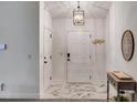 Bright foyer with marble tile flooring, white walls, and modern lighting at 245 Raleigh Way, Villa Rica, GA 30180