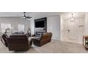 Spacious living room with a modern fireplace, large tv, and cozy seating at 245 Raleigh Way, Villa Rica, GA 30180