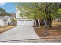Pleasant two-story house featuring a two-car garage, brick accents, and a welcoming staircase entrance at 2172 Creekview Trl, Decatur, GA 30035