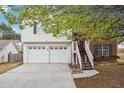 Inviting home with a two-car garage, brick accents, and a quaint entrance staircase at 2172 Creekview Trl, Decatur, GA 30035