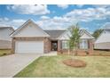 Beautiful brick home with a two-car garage and a well-manicured front lawn at 939 Park Place St, Social Circle, GA 30025