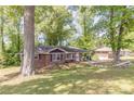 Well-maintained brick home with lush green front yard and mature trees at 1157 Helen St, Morrow, GA 30260