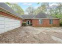 Classic brick home with attached garage and traditional curb appeal, showcasing a timeless design and structure at 4367 S Berkeley Lake Nw Rd, Duluth, GA 30096