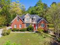 Stately two-story brick and stucco home with lush greenery, creating a picturesque and welcoming atmosphere at 1920 Lee Patrick Dr, Dacula, GA 30019