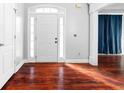 Inviting foyer with hardwood floors, white door, and sidelights, creating a bright and open entryway at 1920 Lee Patrick Dr, Dacula, GA 30019