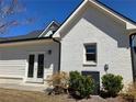 Bright white brick home featuring a well-maintained lawn and modern air conditioning unit at 5099 Noble Village Way, Lilburn, GA 30047