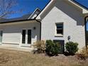 Bright white brick home featuring a well-maintained lawn and modern air conditioning unit at 5099 Noble Village Way, Lilburn, GA 30047