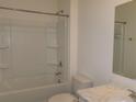 Clean bathroom featuring a shower-tub combo and a marbled vanity at 120 Montgomery Dr, Stockbridge, GA 30281