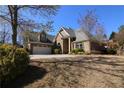 Inviting brick home with a two-car garage, surrounded by a well-kept lawn and mature landscaping at 1520 Camden Cove Dr, Cumming, GA 30040