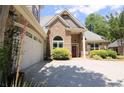 Beautiful brick home featuring a well-kept lawn, two-car garage, and attractive front entrance at 1520 Camden Cove Dr, Cumming, GA 30040