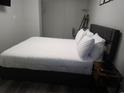 Comfortable bedroom with a plush bed, wooden nightstand, and ample space at 215 Piedmont Ne Ave # 304, Atlanta, GA 30308