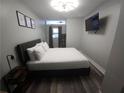 Well-appointed bedroom with modern lighting, wall-mounted TV, and decor at 215 Piedmont Ne Ave # 304, Atlanta, GA 30308
