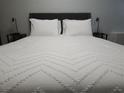 Cozy bedroom with a plush bed, stylish lamps, and soft lighting at 215 Piedmont Ne Ave # 304, Atlanta, GA 30308