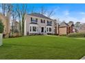A well-maintained two-story residence showcasing a large front lawn and classic architectural details at 2018 Sugar Maple Ln, Woodstock, GA 30189