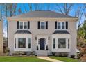 Beautifully maintained two-story home features a classic design and manicured front yard at 2018 Sugar Maple Ln, Woodstock, GA 30189