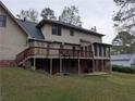 Back exterior featuring a large deck and patio area, perfect for outdoor entertaining and relaxation at 3015 Ascot Ln, Roswell, GA 30076