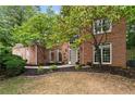 Attractive brick facade with large windows, a welcoming front door, and well-maintained landscaping at 3851 Westwick Nw Way, Kennesaw, GA 30152