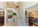 Grand foyer featuring a staircase, chandelier, tile flooring, and views into adjoining living spaces at 3851 Westwick Nw Way, Kennesaw, GA 30152