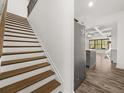Open staircase leading to the upper level, adjacent to the kitchen and stainless steel refrigerator at 372 Mulberry Se Row, Atlanta, GA 30354
