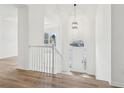 Bright entryway featuring hardwood floors, high ceilings, a hanging pendant light, and white trim at 4554 Alaspair Ln, Acworth, GA 30101