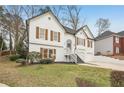 Beautiful two-story home with white exterior, landscaped front yard, and attached two-car garage at 4554 Alaspair Ln, Acworth, GA 30101