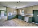 Bright kitchen with two-tone cabinets, modern appliances, and vinyl tile flooring at 5190 Paul Sw Cir, Conyers, GA 30094